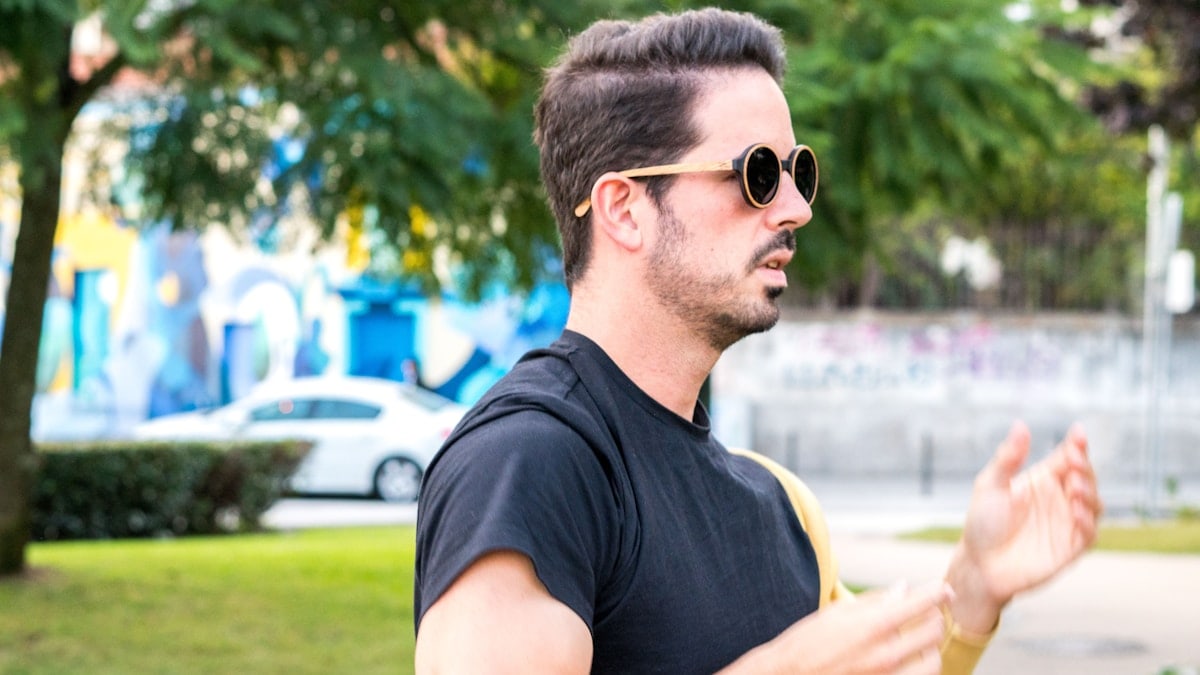 A man wearing sunglasses and holding a frisbee